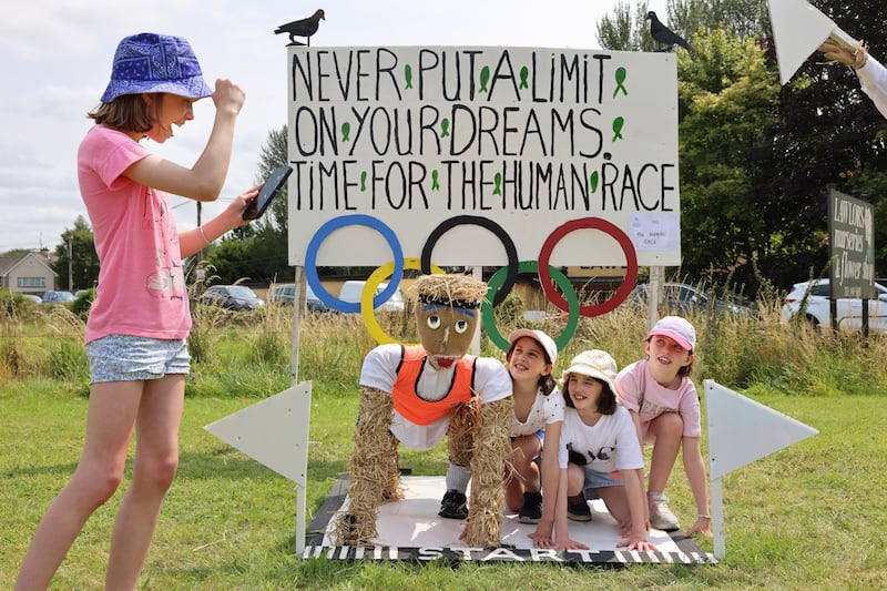Sive O’Sullivan takes a photograph of Faye Gordon, Nina Gordon and Ruth O’Sullivan, all from Kilkenny. Photograph: Dara Mac Dónaill