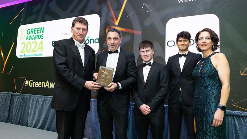 Tricia Murray, energy services manager of Energia Group and Minister Eamon Ryan, presents the sustainable energy achievement award to AbbVie team