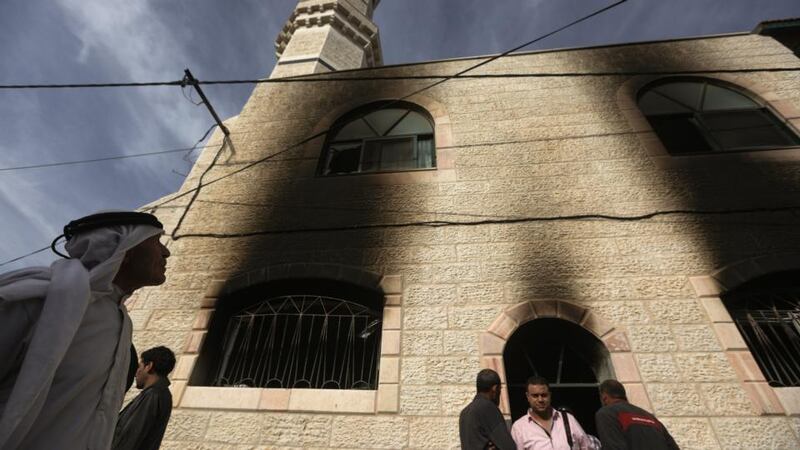 Palestinians inspect the damage at a mosque of the West Bank village of Mghayr following an overnight attack blamed by locals on Israel settlers. Photograph: Atef Safadi/Epa