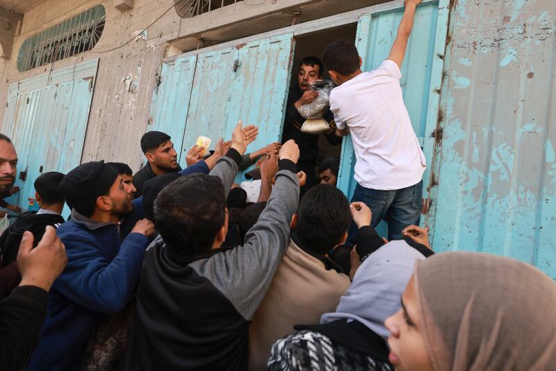 Palestinians scramble to buy  sugar and sage from a shop at the Bureij refugee camp in the central Gaza Strip. Photograph: Mohammed Abed/AFP via Getty Images