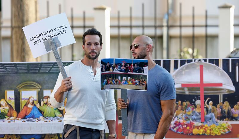 Andrew Tate (right) and his brother Tristan hold placards during a protest in front of the French embassy in Bucharest, Romania, showing displeasure at the opening ceremony of the Paris Olympic Games. Photograph: EPA-EPE