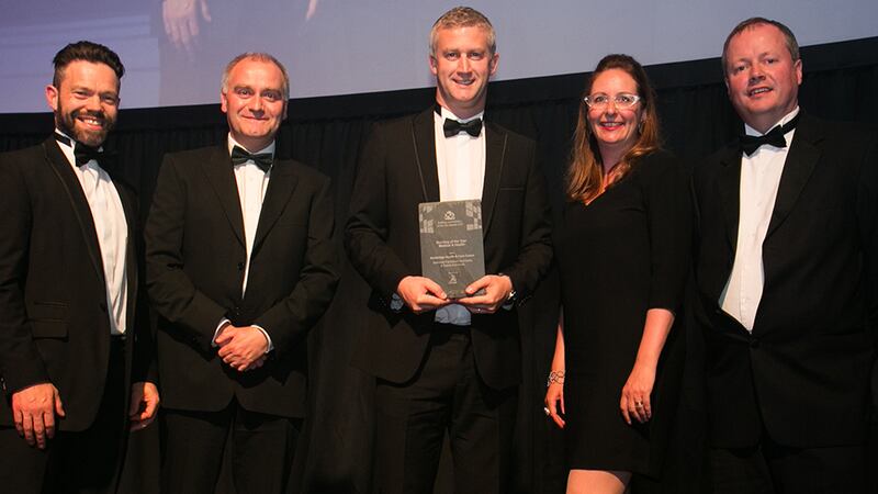 Liam Brew, Operations Director, Actavo presents the Building of the Year - Medical & Health Award to Kennedy FitzGerald Architects & Avanti Architect team.