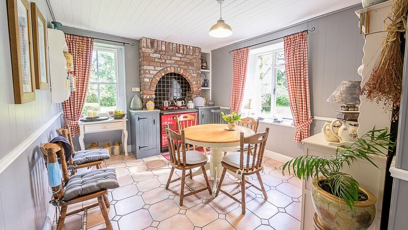 This charming four-bed is set on 1.75 acres of beautifully maintained gardens bounded to the north by the river Clodagh.