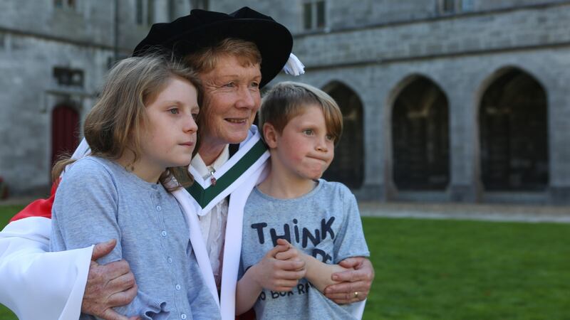 Catherine Corless, who  was conferred with an Honorary Doctorate of Arts at NUI Galway, is pictured with her grandchildren Aoife and Beineán. Photograph: Aengus McMahon.