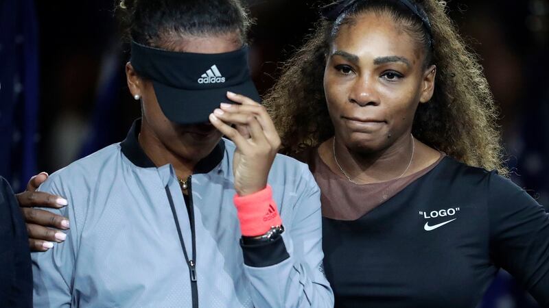 Naomi Osaka is hugged by Williams. Photo: Julio Cortez/AP Photo