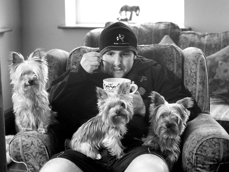 Michael Dunlop enjoys a bowl of soup with his canine companions. Photograph: Stephen Davison

