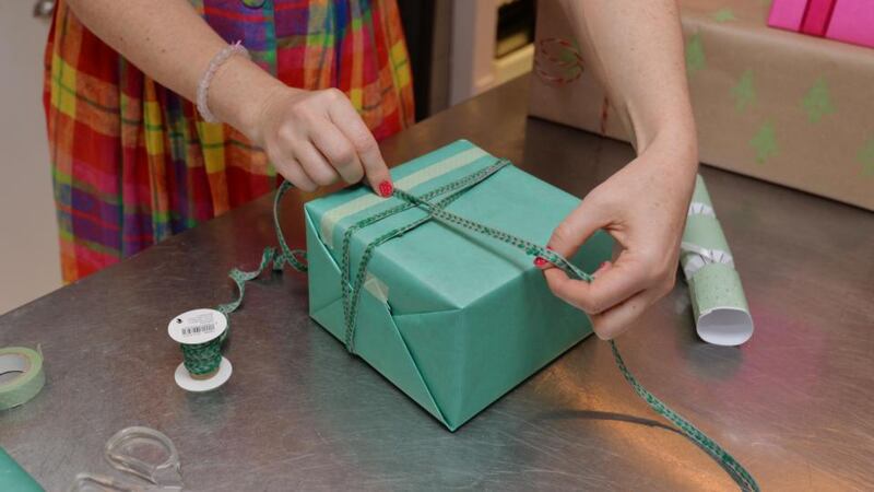 Step 7: If you can tie your shoelace, then you can tie a ribbon around a present. I’m using a thin ribbon, so I’ll wrap it round a few times, starting underneath the present, because I like to do a crossover. Photograph: Alan Betson