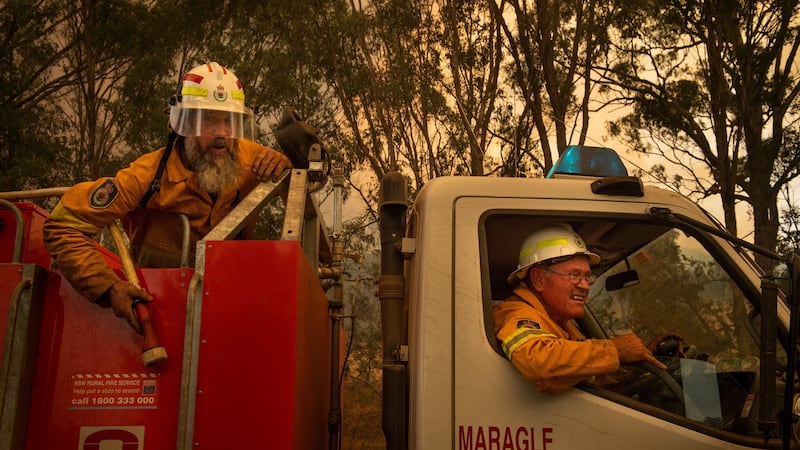 Mark Bourke and Greg Lyons ride in a firefighting water truck near Maragle,on Friday. Photograph: Matthew Abbott/The New York Times