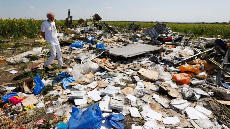 George Dyczynski wears a shirt bearing an image of his daughter Fatima, as he walks through wreckage during his visit to the crash site of the downed Malaysia Airlines Flight MH17, during a visit to the crash site near the village of Hrabove (Grabovo), in Donetsk region yesterday. Media reports state that his daughter Fatima was aboard the Malaysia Airlines plane. Photograph: Reuters