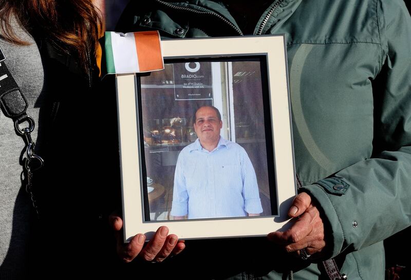 Clare Gormley, holding an photograph of shopkeeper Akram Hussein.  Photograph: Maxpix
