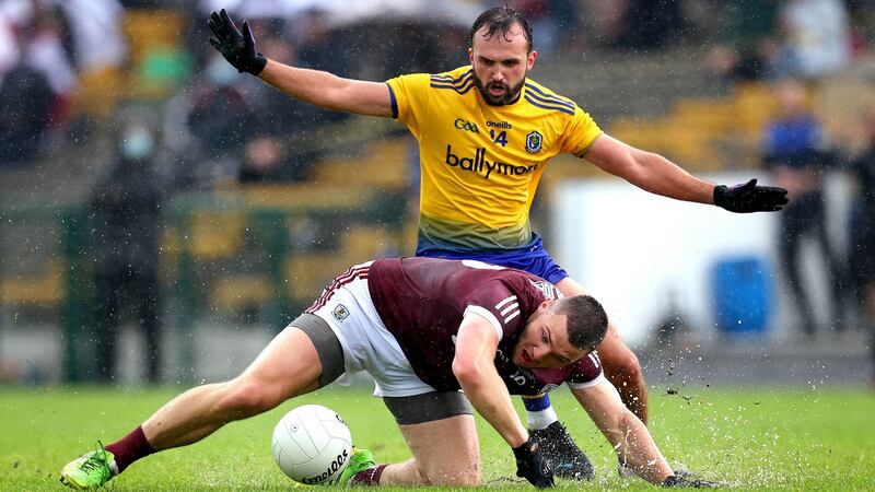Galway’s Damien Comer and Donie Smith of Roscommon clash in the rain. Photo: Ryan Byrne/Inpho