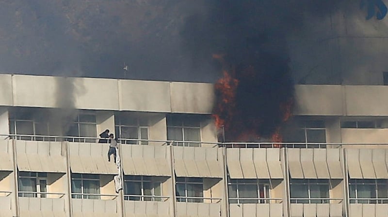 A man tries to escape from a balcony at Kabul’s Intercontinental Hotel during an attack by gunmen in Kabul. Photograph: Omar Sobhani/Reuters