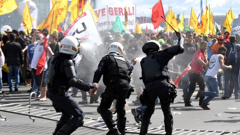 Protesters clash with police during a protest against labour and social security reforms and Michel Temer in Brasília. Photograph: Evaristo Saevaristo Sa/AFP/Getty