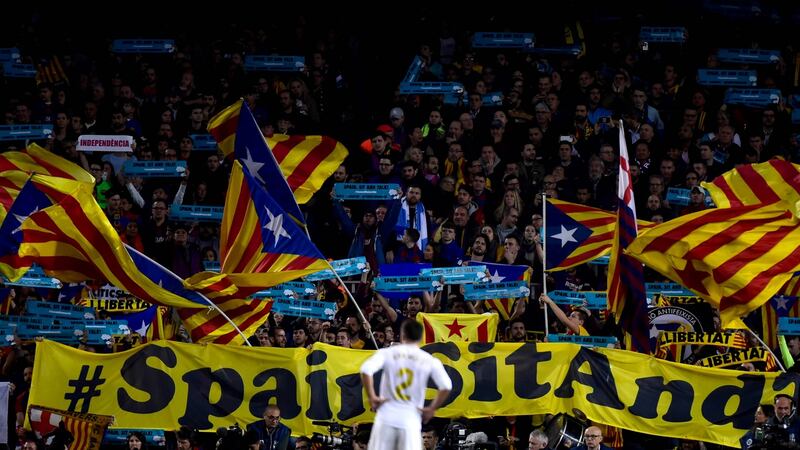 Real Madrid defender Dani Carvajal looks at Barcelona’s supporters waving Catalan pro-independence ‘Estelada’ flags during the Clasico match at the Nou Camp. Photograph: Jose Jordan/AFP via Getty Images