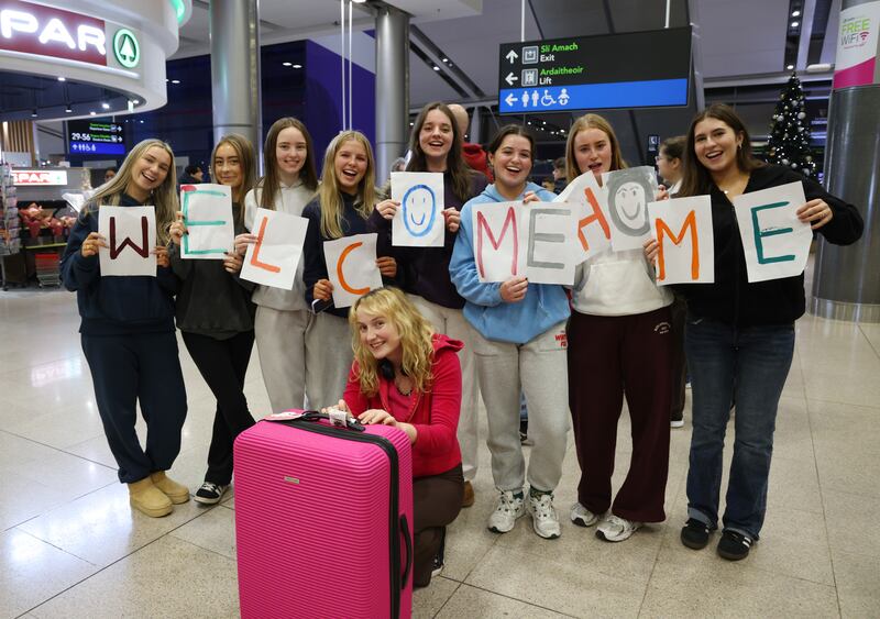 Lucy Naessens from Skerries (foreground) is welcomed home from Notre Dame by a bunch of her old school friends at Dublin Airport. Photograph: Bryan O’Brien/The Irish Times

