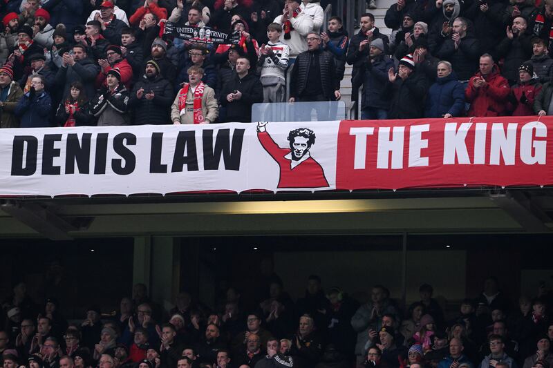 Manchester United fans displaying a banner  for Denis Law during the Premier League match against Brighton at Old Trafford on January 19th, 2025.  Photograph: Stu Forster/Getty Images