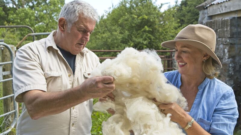 Blathnaid Gallagher inspects the wool for quality with her husband Niall on their farm in Ballinasloe.
