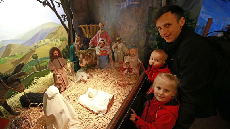 Minni (4), sister Lotta (1) and Dad Petr Spodniak from Dublin enjoying the moving crib installations at St Martin Apostolate  on Parnell Square in Dublin. Photograph: Nick Bradshaw