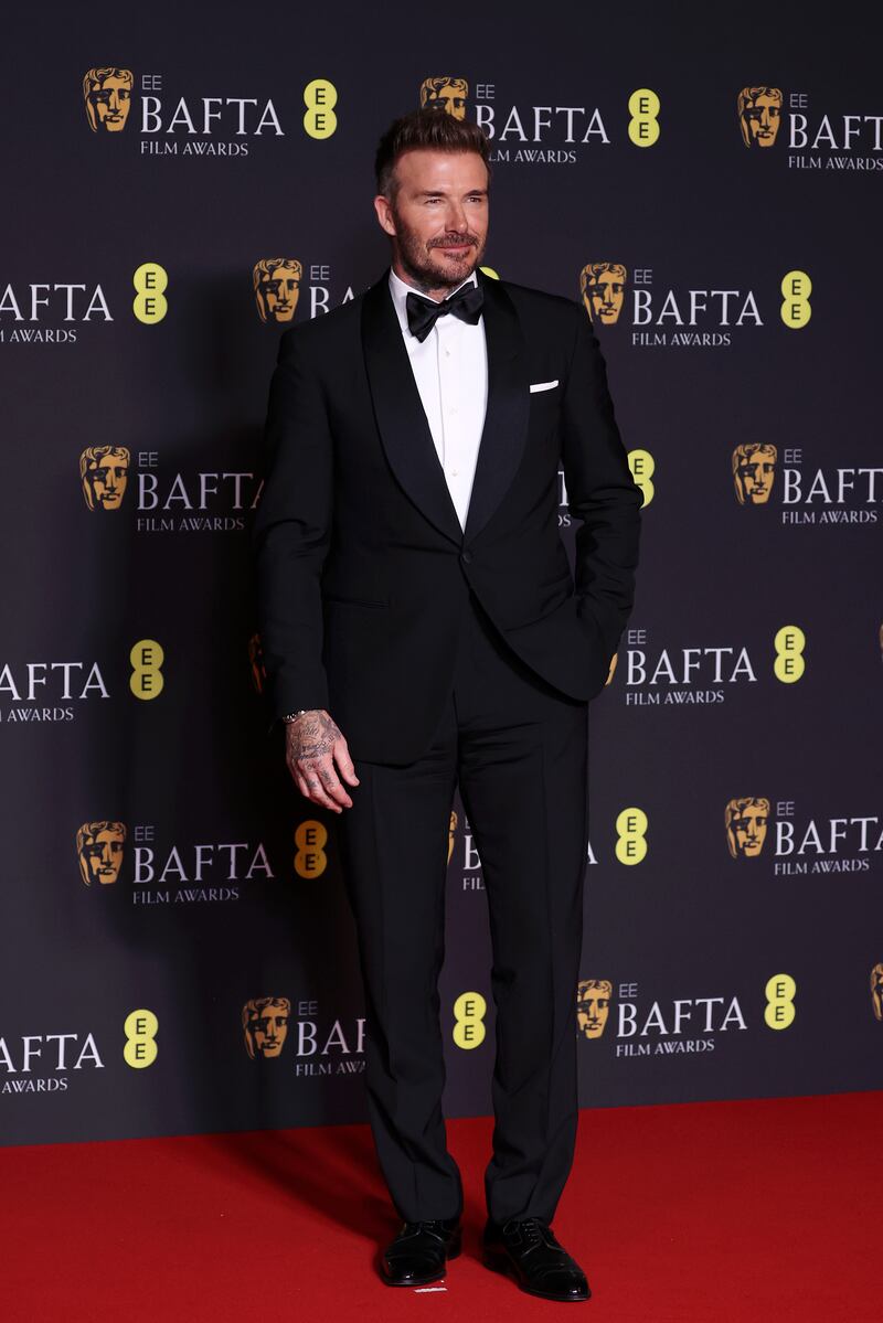 David Beckham in classic tuxedo as he prepared to present an award at the Baftas. Photograph: John Phillips/Getty Images