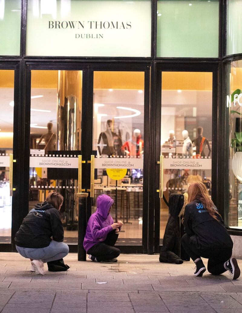 Roisin Casey (R) and Daire Moriarty, both members of the Dublin Simon rough sleeper outreach team speak to a homeless woman on Dublin’s Grafton Street. Photograph: Damien Eagers