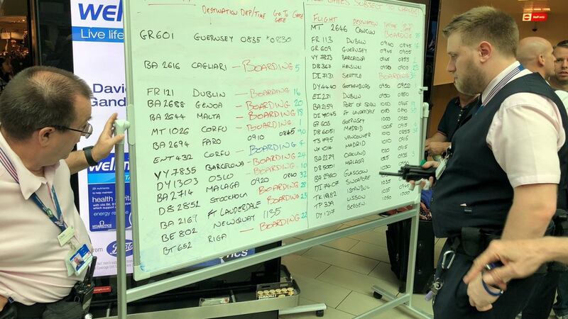 Airport staff write on a whiteboard at Gatwick, Britain. Photograph: @EVDB/Twitter/via Reuters
