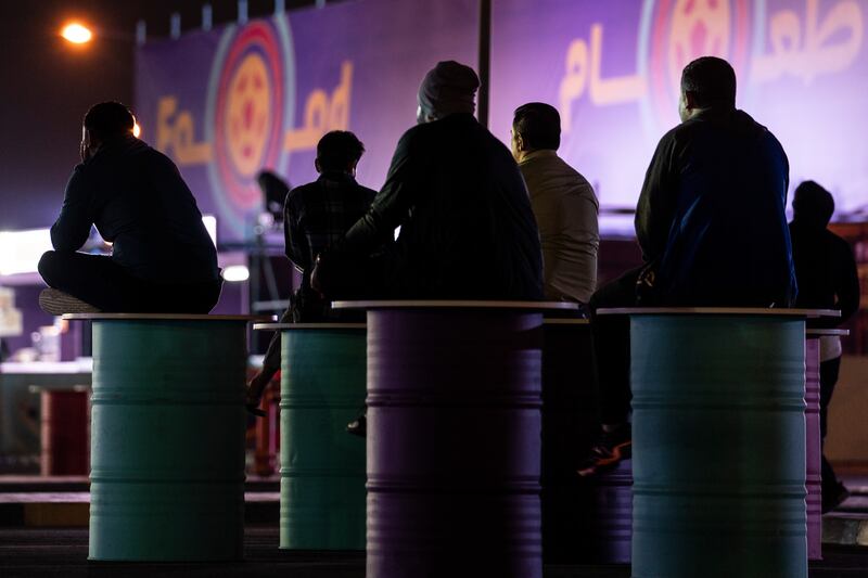 Workers watch matches in the Asian Town fan zone in Doha, Qatar. Photograph: Erin Schaff/The New York Times