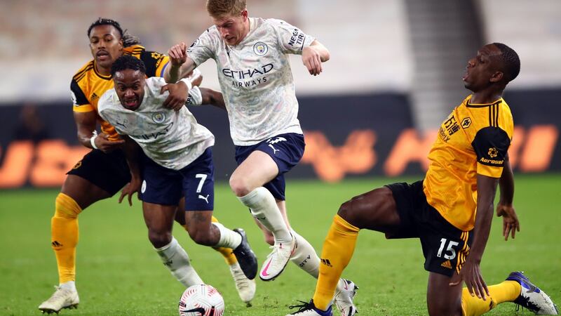 Kevin De Bruyne is challenged by Willy Boky during Man City’s win over Wolves. Photograph: Marc Atkins/EPA