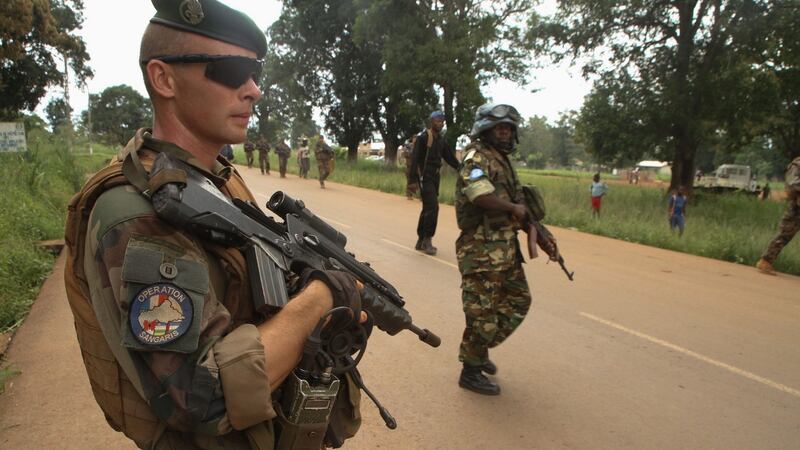 Burundian soldier from the United Nations Multidimensional Integrated Stabilisation Mission in the Central African Republic (MINUSCA - on right) and French Sangaris legionnaires from the Tactical Inter-forces Group Centurion, patrolling in Sibut, north of Bangui, Central African Republic, on September 25th, 2015. Photograph: Edouard Dropsy/AFP/Getty Images