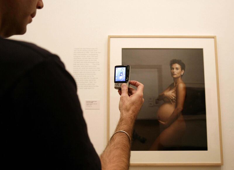 A visitor photographs Annie Leibovitz's portrait of a pregnant Demi Moore, during the launch of her exhibition Annie Leibovitz: A Photographer's Life 1990-2005. Photograph: Yui Mok/PA