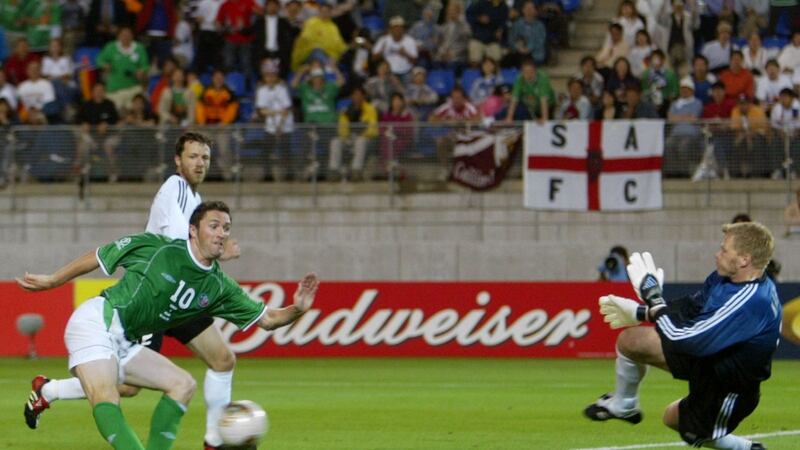 Ireland’s Robbie Keane  scores past Germany’s Oliver Kahn, watched by Thomas Linke, during their Group E match at the World Cup Finals in Japan in June 2002. The match ended in a 1-1 draw. Photograph: Kieran Doherty/Reuters