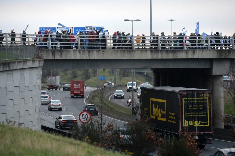INMO members from Connolly Hospital at the start of the nurses 24-hour strike, pictured on a bridge above the M50 motorway Photograph: Dara Mac Dónaill/The Irish Times