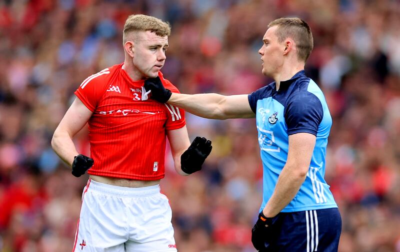 Con O’Callaghan of Dublin tries to keep Louth’s Peter Lynch at arm's length. Photograph: James Crombie/Inpho