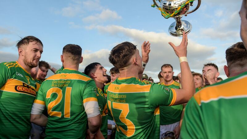 Dunloy Cuchulainns celebrate with the cup after victroy in the Antrim hurling final. Cathal McOscar/Inpho