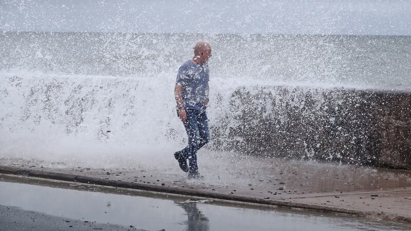 A man gets hit by a wave crashing on the Front Strand in Youghal, Co Cork. Photograph: Niall Carson/PA Wire