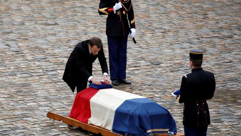French president Emmanuel Macron at the  coffin of Lieut Col Arnaud Beltrame, killed after taking the place of a female hostage during a  siege last month. Beltrame’s sacrifice was wrapped up in many things. Photograph: Christian Hartmann/Reuters
