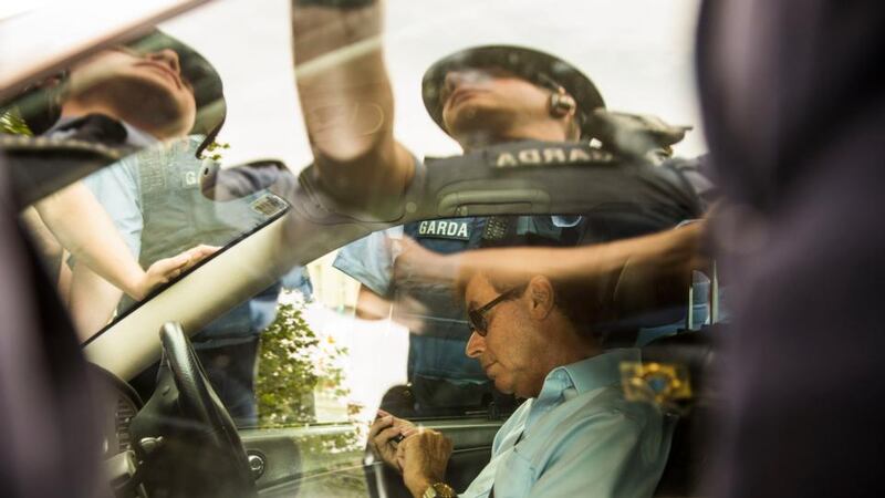 Gardaí surround former minister for justice Alan Shatter’s car  from driving through  the gates of Leinster House by protesters on Wednesday. Photograph: Dara Mac Dónaill/The Irish Times