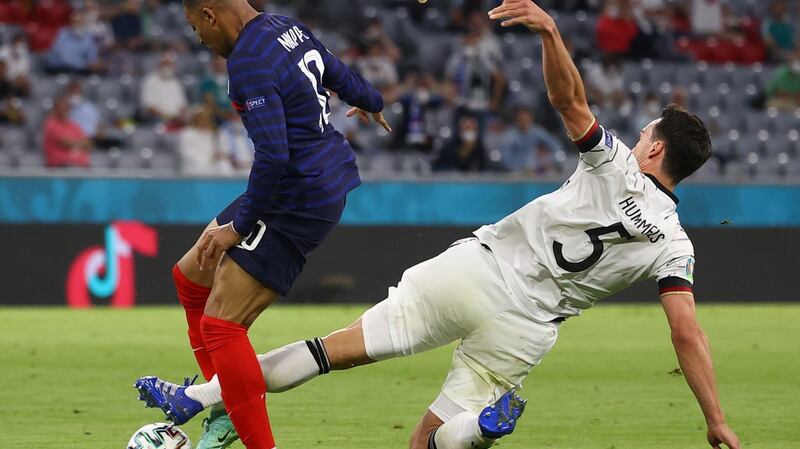 Mats Hummels gets a foot in to dispossess Kylian Mbappe. Photograph: Kai Pfaffenbach/EPA