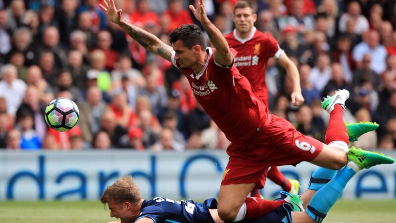 Lovren bundles over Bamford and is lucky to avoid a red card. Photo: Peter Byrne/PA