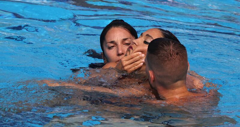 Anita Alvarez's airways are cleared by her coach after she was brought to the surface