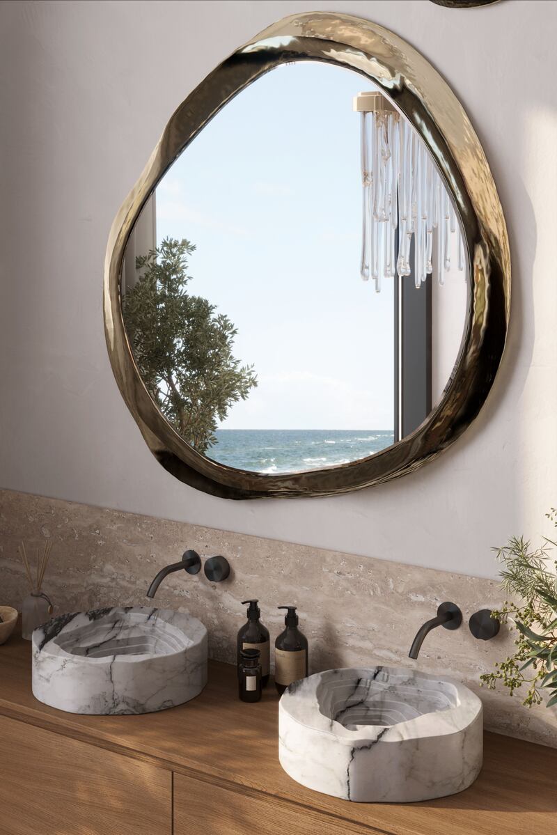 Natural finishes bring a luxe spa feel to home bathrooms: Duorum Vessel sinks in marble, from Maison Valentina, and Halo mirror, by Boca do Lobo, caffelattehome.com