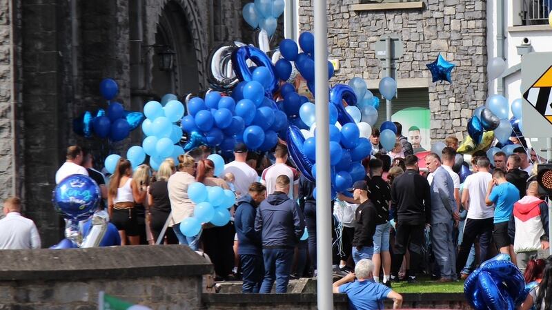 Family and friends of Myles Harty gather outside St Munchin’s Church in Limerick city on Saturday afternoon.