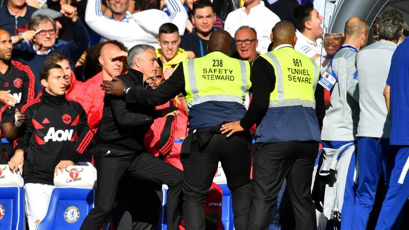 Manchester United manager Jose Mourinho is restrained by stewards after reacting to the celebrations from Chelsea’s second assistant coach Marco Ianni after Ross Barkley’s late equaliser at Stamford Bridge. Photograph: Dylan Martinez/Reuters