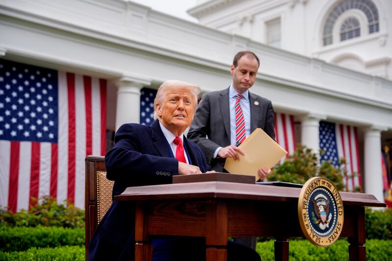 US President Donald Trump, accompanied by White House staff secretary Will Scharf, prepares to sign executive orders imposing tariffs on imported goods Photograph: Getty Images