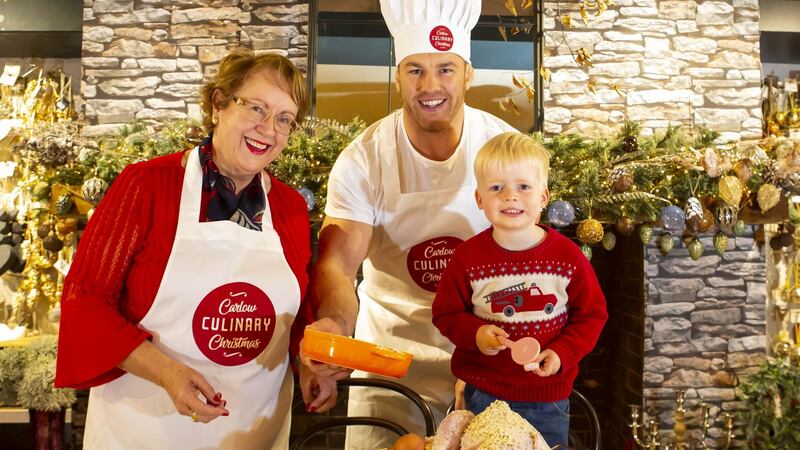 Sean O’Brien prepares for Carlow Culinary Christmas with Rachel Doyle of The Arboretum and three-year-old Iarlaith Flannery. Photograph: Mary Browne