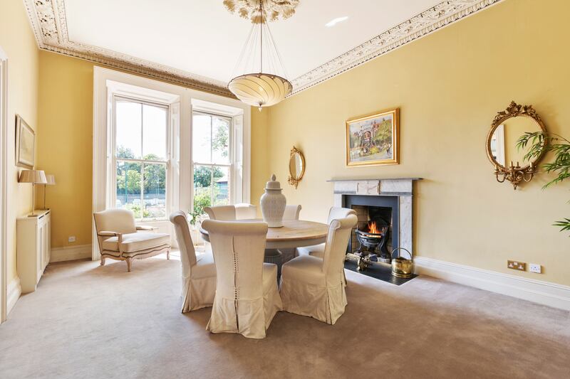 Formal diningroom with marble fireplace and large sash picture windows