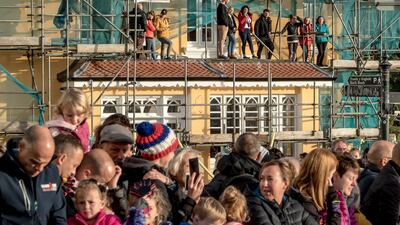 Spectators stand on scaffolding to watch the Wales Ironman in Tenby.