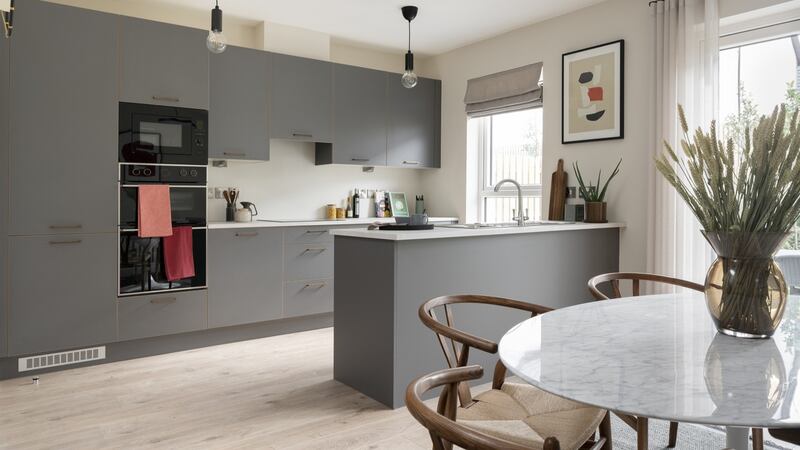 The kitchen-dining area is fitted with grey onyx units and laminated worktops