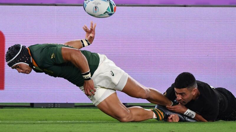 New Zealand’s outhalf Richie Mo’unga  tackles South Africa’s wing Cheslin Kolbe. Photograph:  Toshifumi Kitamura/Getty Images