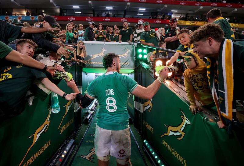 Ireland's captain Caelan Doris gives away his boots to fans after the  win over South Africa in Durban. Photograph: Dan Sheridan/Inpho
