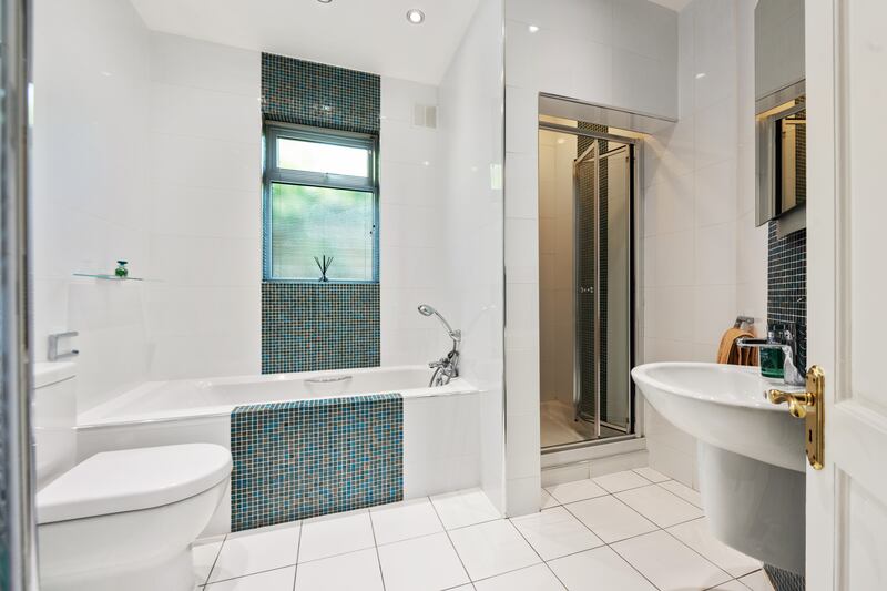 Family bathroom with mosaic tiling.